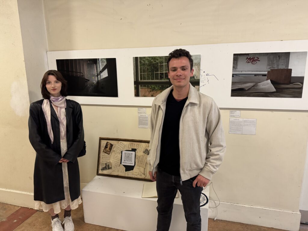 Two students standing in front of their photography exhibition