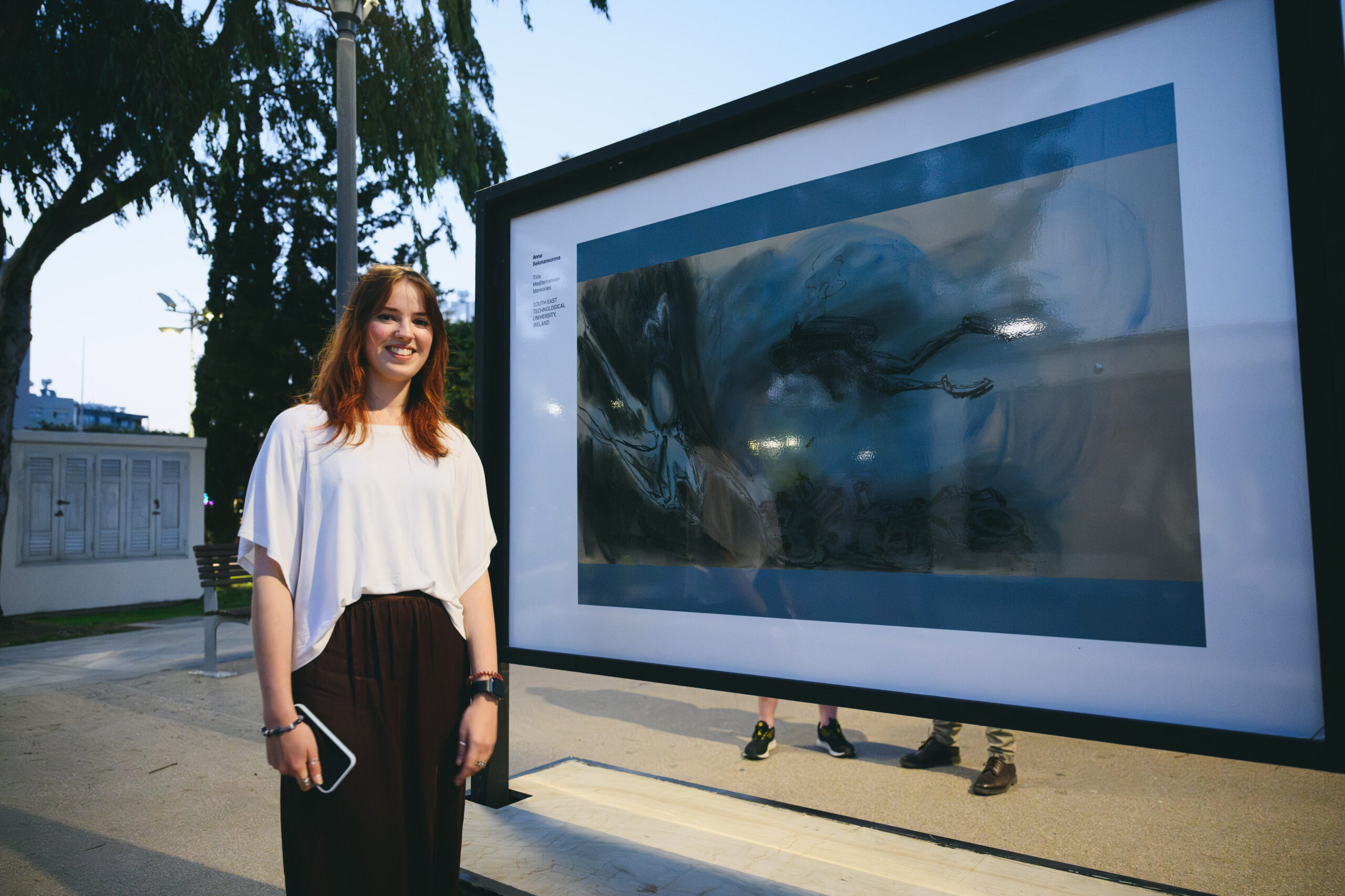SETU student Anna standing beside her artwork
