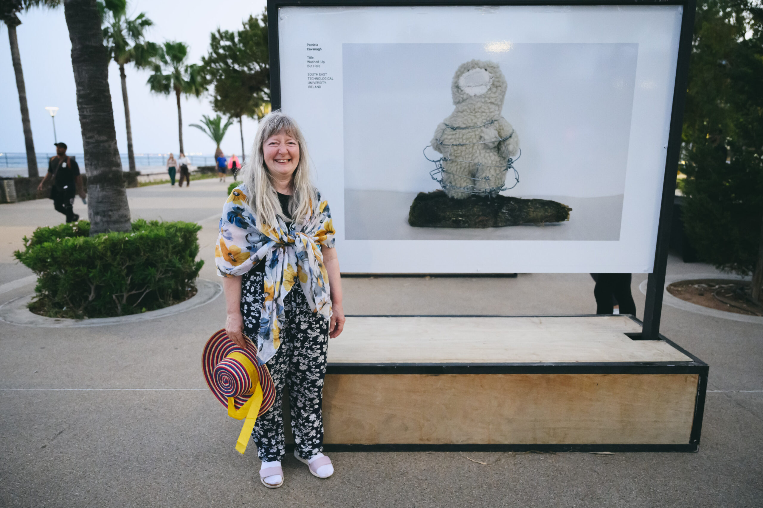 SETU student Patricia stand beside her artwork 
