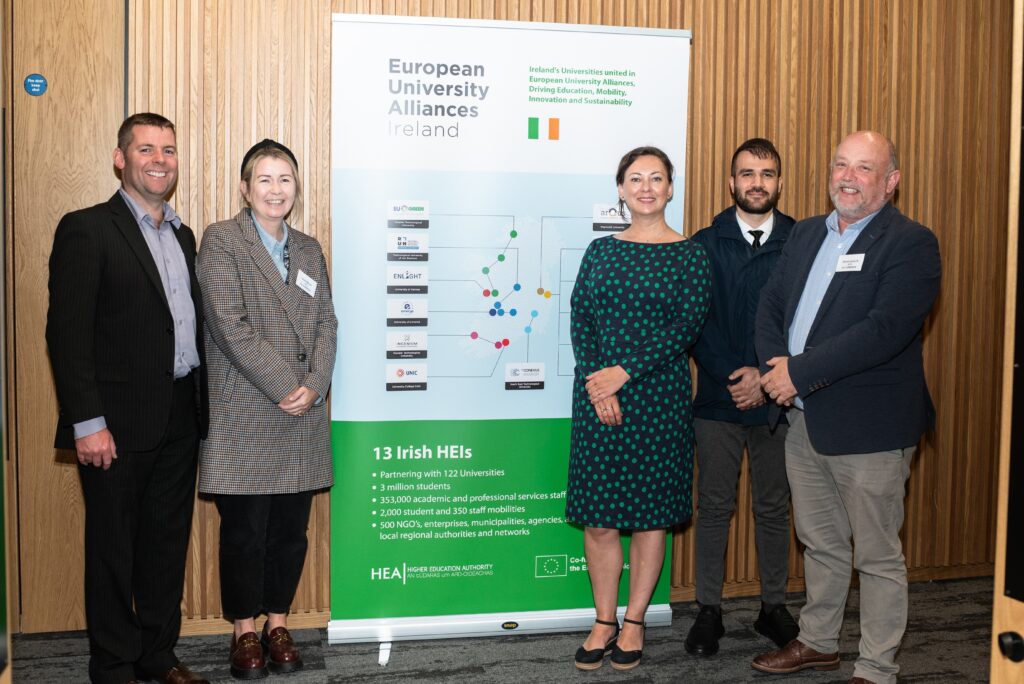 Group of people standing in front of pull-up banner