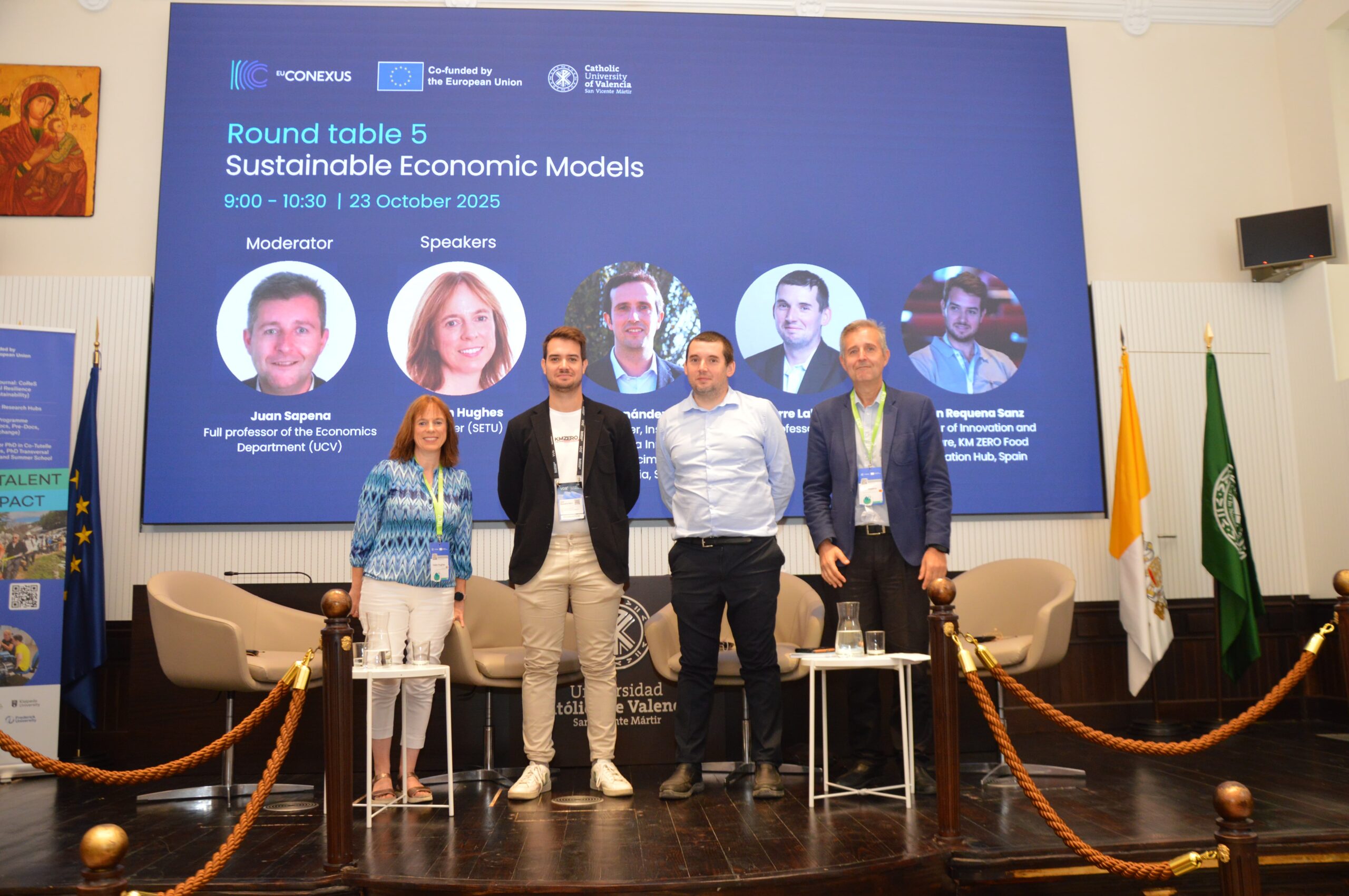 Four people on stage after presentation