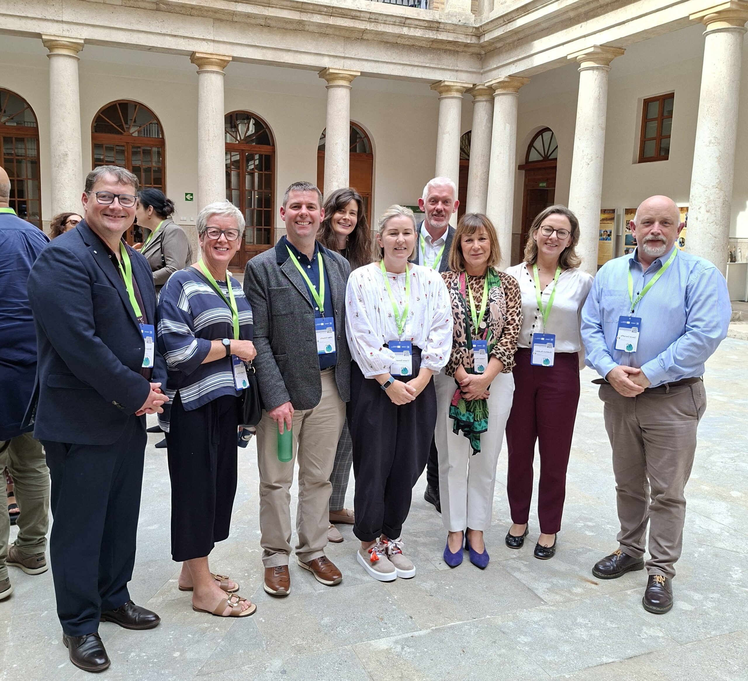 Group of people standing in a university courtyard 