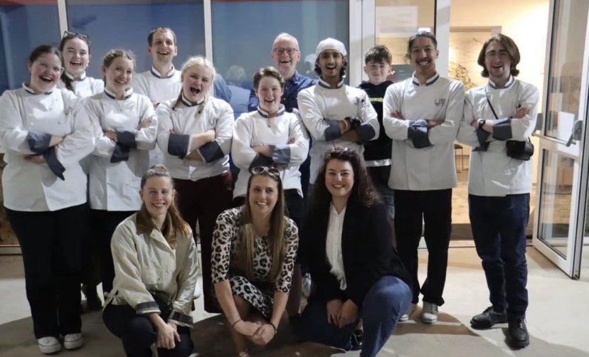 Group of students in chef uniforms with staff