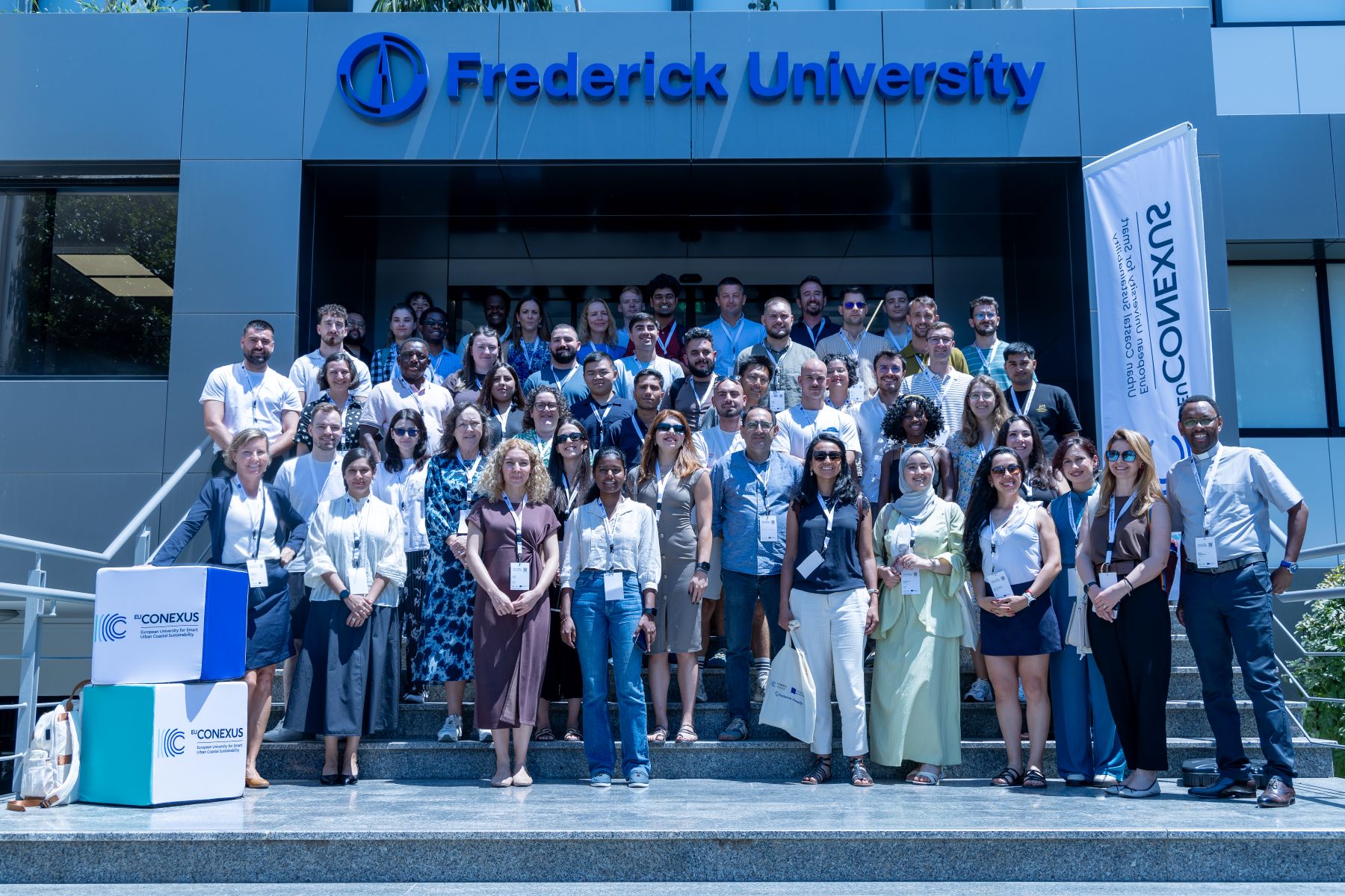 Students and staff standing on steps of university